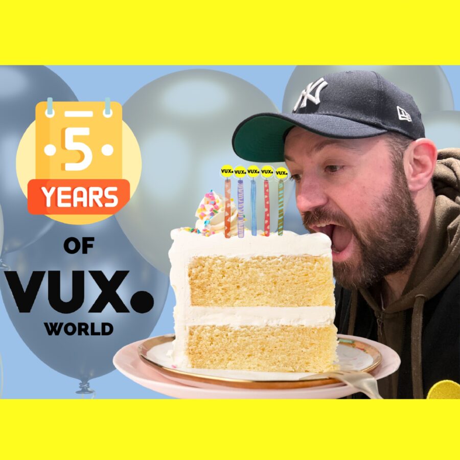 An image of Kane Simms biting a giant cake to celebrate 5 years of VUX World